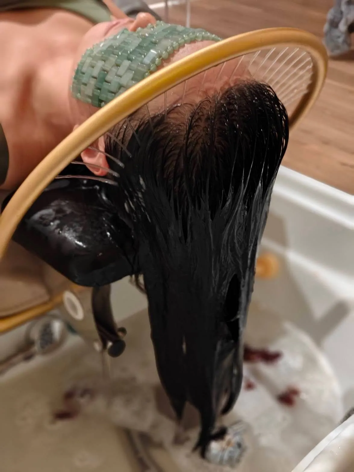 Scalp wash under the gold halo ring during a Korean head spa at Fiona's Day Spa in Coon Rapids, MN
